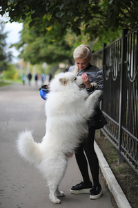 Lovely girl on a walk with a beautiful dog 