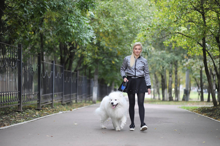 Lovely girl on a walk with a beautiful dog 