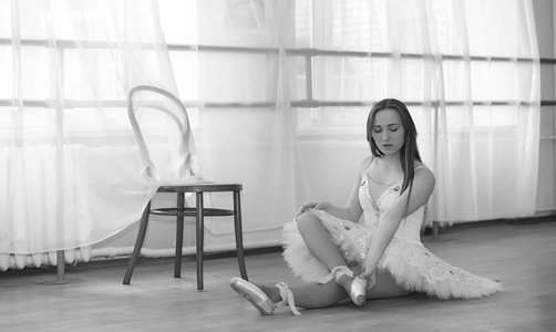Young ballet dancer on a warmup. The ballerina is preparing to 