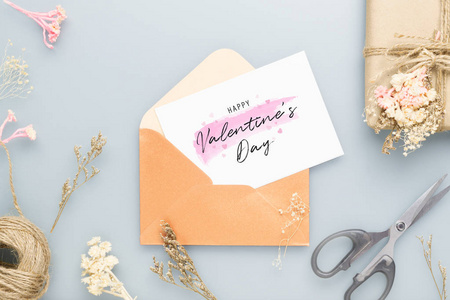 Mockup postcard and envelop on work table with Happy valentines 