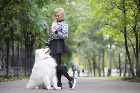 Lovely girl on a walk with a beautiful dog 