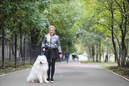 Lovely girl on a walk with a beautiful dog 