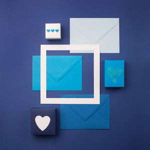 Blue envelopes, gifts and white hearts on classic blue 