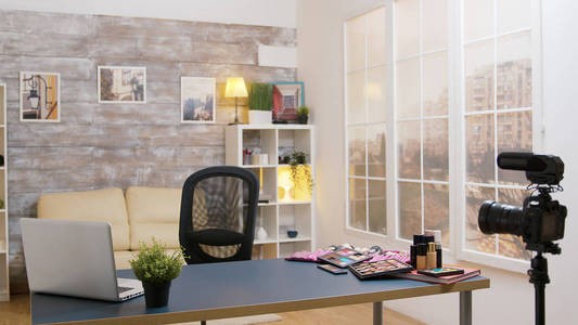 Empty vlogger room with beauty cosmetics on the table and a vide