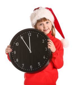 戴着圣诞帽的小女孩，白色背景的钟。圣诞倒计时概念