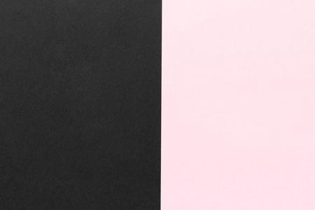 双色几何黑色和粉红色对半的纸张背景.简约双色织物照片