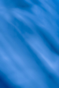 蓝色抽象艺术背景，丝绸质地和摩托波浪线