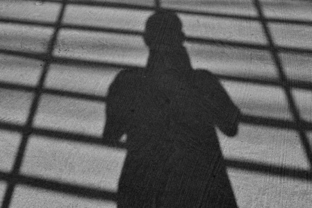 The shadow of human apper on the street. 