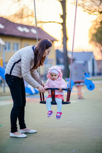 Happy mother and daughter in the park. Beauty nature scene with 