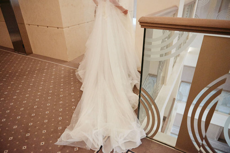 Beautiful bride wearing long fashion wedding dress walking down 