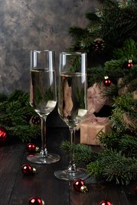 Christmas glasses of champagne and fir tree branches 