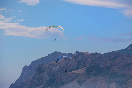 Parachutists on paragliders fly in the sky 