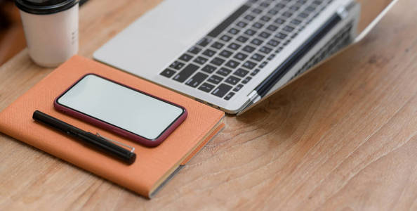 Cropped shot of  workplace with smartphone, laptop compute and o