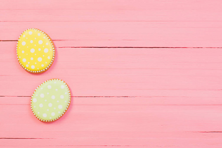 Easter decorations on pink wooden background 