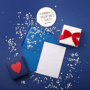 Empty card with blue envelope, gift and red heart on classic blu