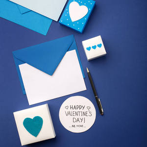 Blue envelope, gifts and white hearts on classic blue 
