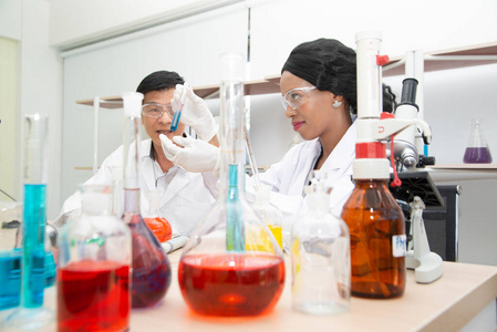 Two scientists are working in laboratory. Young female researche