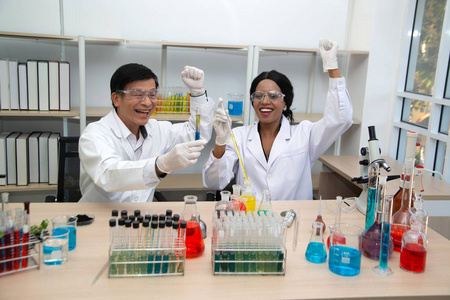 Two scientists are working in laboratory. Young female researche