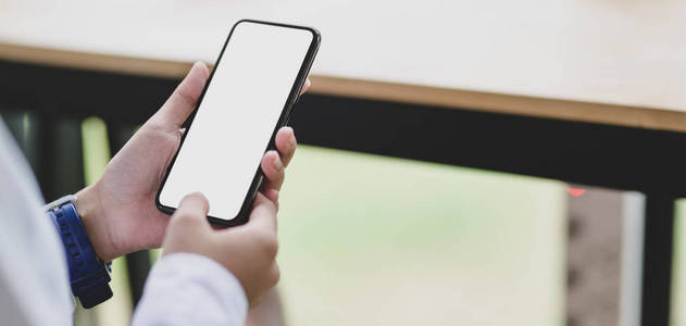 Cropped shot of young businesswoman using blank screen smartphon