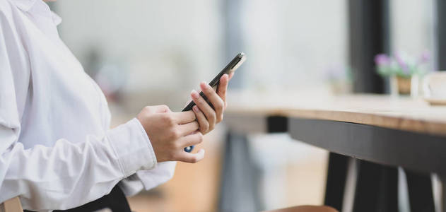 Cropped shot of young businesswoman using blank screen smartphon