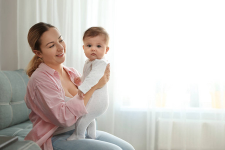 一个年轻的女人带着她可爱的孩子在家。文本空间