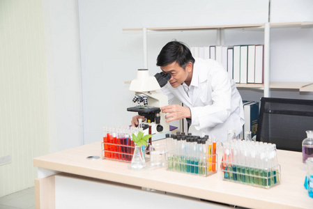 Scientist using Microscope in Laboratory. 