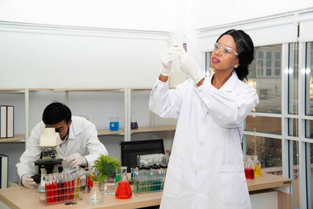 scientist with equipment and science experiments, laboratory gla