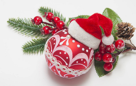 Christmas balls and berries on white table top view. 