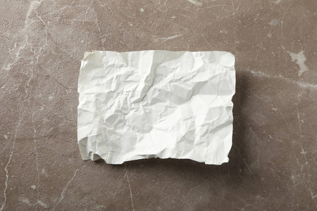 Empty crumpled paper on grey background, top view