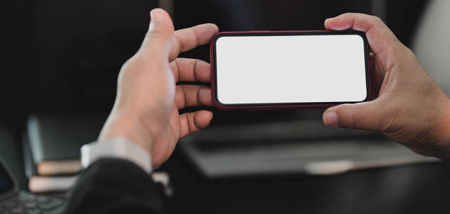 Cropped shot of professional businesan holding blank screen 