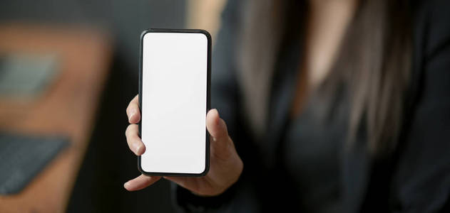 Closeup view of businesswoman showing blank screen smartphone f