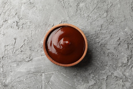 Tasty barbecue sauce, ingredients on grey background, space for 