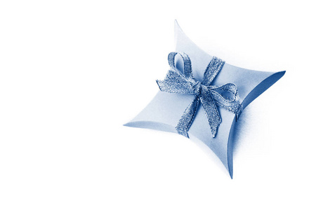 Isolated classic blue paper gift box with satin ribbons bows on 