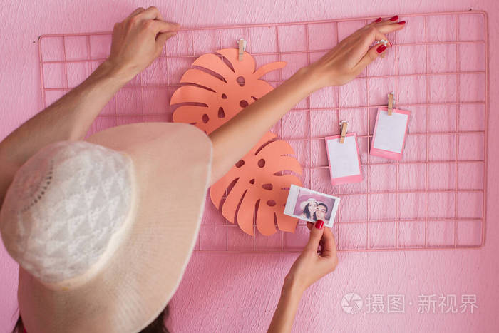 女孩和一个年轻人把一张完成的照片贴在墙上