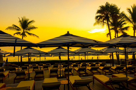 umbrella and chair around outdoor swimming pool in hotel resort 