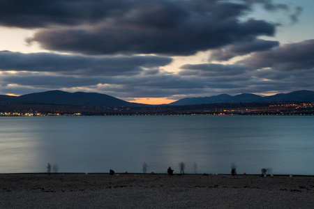 Fishermen on the shore of Gelendzhik Bay stand in a row and catc