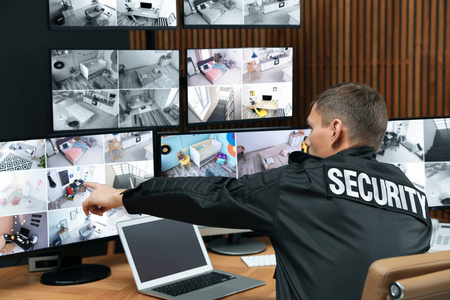 Security guard with portable transmitter monitoring modern CCTV 