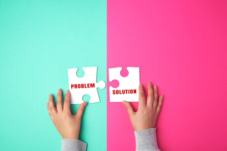 two empty paper white pieces of puzzles in female hands, puzzle 