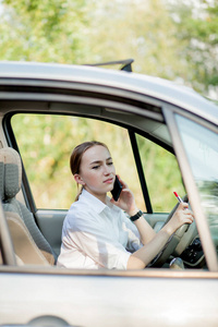 Picture of young businesswoman speaks by phone and doing makeup 