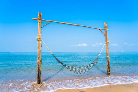 Empty hammock swing on the beautiful beach and sea