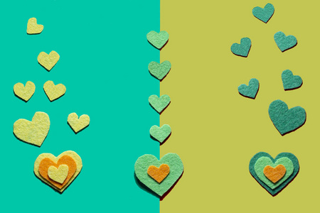 Felt hearts on the green and otrange background. 