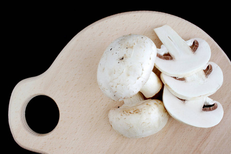 Fresh mushrooms on wooden board. 