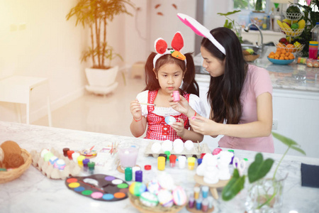 Cute little asian child girl wearing bunny ears on Easter day. 