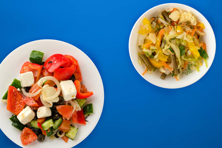  Greek salad on a colored background. Greek salad on a white pla