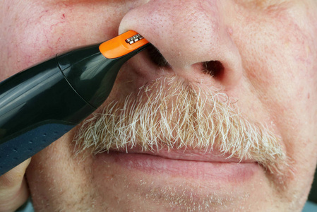 身体护理,生活方式,都市美男.大师用修剪器,特写镜头为客户剪鼻毛.