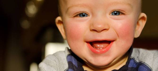 Closeup portrait of happy toddler with beautiful smile which sho