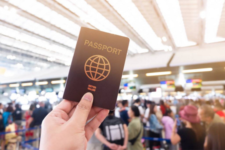 A traveler holding passport in airport 