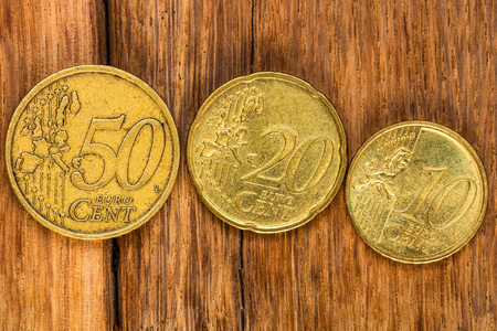 Close up of euro coins on wooden table, 