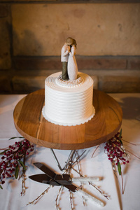 Elegant simple wedding cake table with serving utensils
