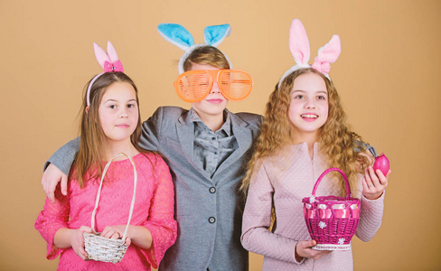 孩子们带着小篮子准备去寻找复活节彩蛋。小组儿童兔子耳朵配件庆祝复活节。复活节活动和乐趣。朋友们在复活节一起玩得开心。准备好猎卵了